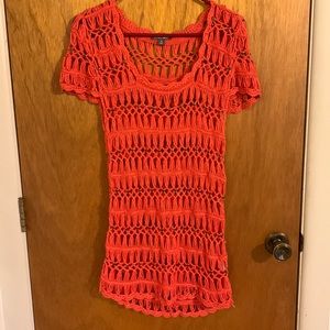 Very cute orange crocheted cover-up with little metal designs Slightly high-low.